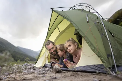 padre acampa con dos niños