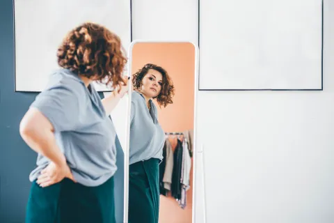 mujer adulta mirándose al espejo