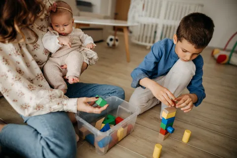 Madre juega con sus dos hijos.