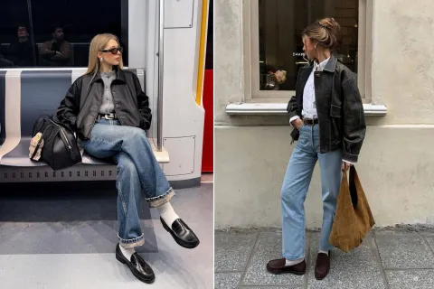 Dos mujeres con chaquetas de cuero, jeans y mocasines posan con estilo urbano en un dístico de moda.